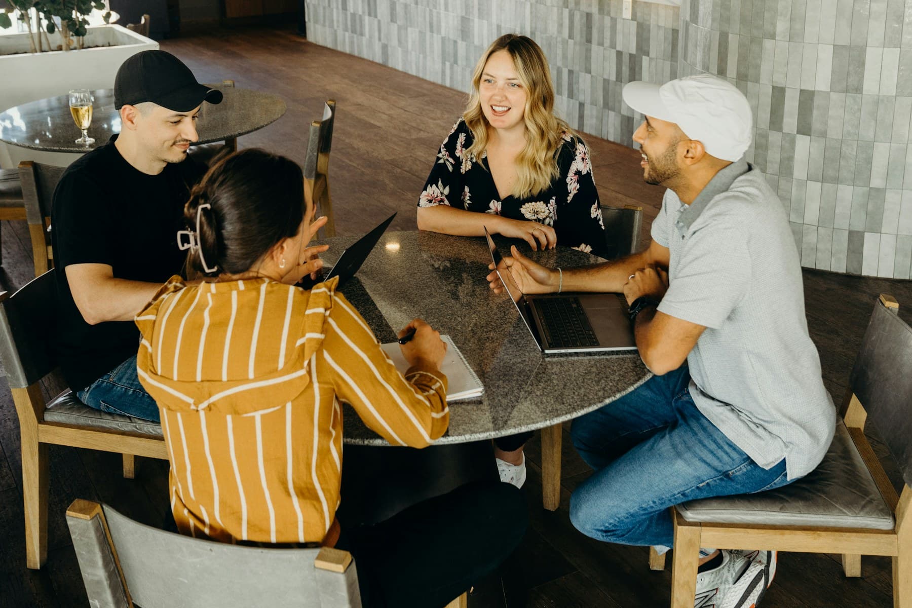 Four colleagues sharing ideas and working together around a table